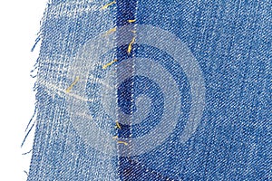 Piece of blue jeans fabric with ripped of back pocket