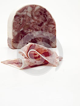 Piece of boar head cut into slices on white background viewed from front photo