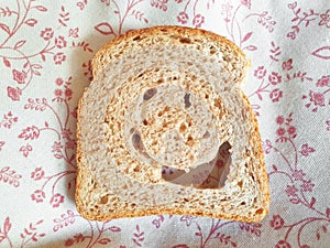 A piece of bread with eyes and mouth