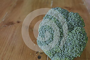 Piece of broccoli on rustic wooden table