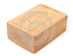 A piece of brown laundry soap on a white background. Isolated