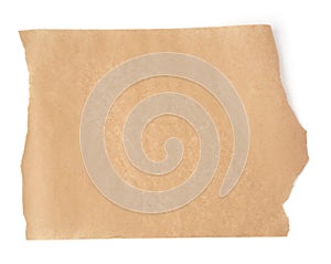 Piece of brown parchment paper with torn edges isolated on a white background