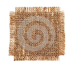 A piece of burlap fabric on a white background. Burlap texture isolate closeup