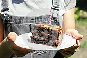 A piece of cake with a blown out candle. A piece of chocolate cake. Candle in chocolate cake.