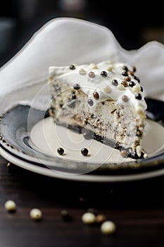 Piece of cake with cream and chocolate balls