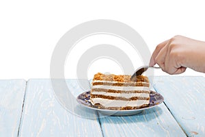 A piece of cake, a female hand with a spoon wants to eat a cake. Proper diet. diet.