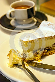 Piece of cake next to a cup of coffee