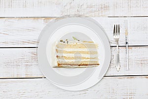 Piece of cake served on plate cutlery and insulin syringe next to it