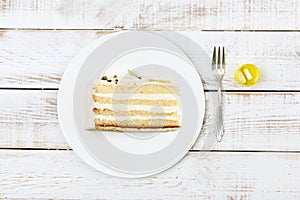 Piece of cake served on plate cutlery and pills regulating blood sugar next to it