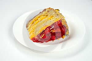 A piece of cake with strawberries and raspberries on a white plate, isolate