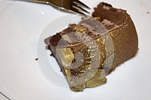 A piece of cake on a white plate close-up