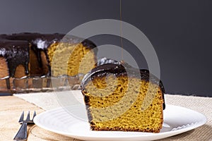 A piece of carrot cake with chocolate icing