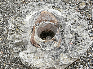 A piece of ceramic pipe at an archaeological site.