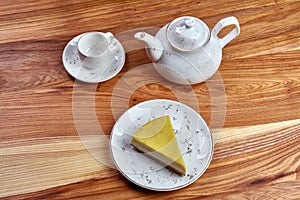 a piece of cheesecake on a plate on a wooden background background