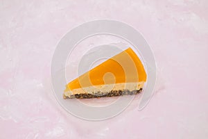 Piece of cheesecake with sea buckthorn and cake