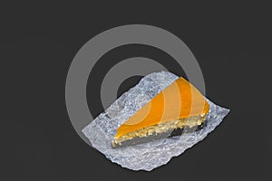 Piece of cheesecake with sea buckthorn and cake