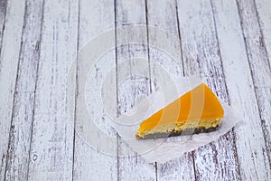 Piece of cheesecake with sea buckthorn and cake