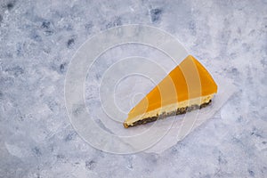 Piece of cheesecake with sea buckthorn and cake