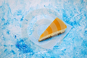 Piece of cheesecake with sea buckthorn and cake