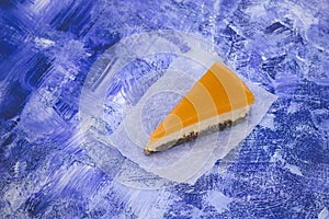 Piece of cheesecake with sea buckthorn and cake