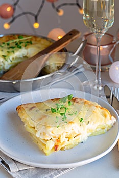 Piece of cheesy scalloped potatoes or potato gratin on a plate,