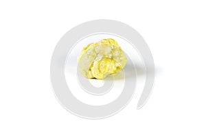 Piece of chewed yellow bubble gum isolated over white