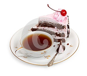A piece of chocolate cake with cherry cream and canned cherries with a cup of tea and a teaspoon, close-up
