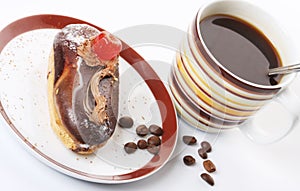 A piece of chocolate cake with coffee