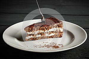 Piece of chocolate cake on a white plate