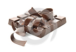 Piece of chocolate with curls on white background
