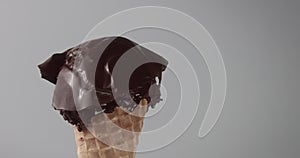 piece of chocolate sheet on ice cream ball and mealting it with hot air