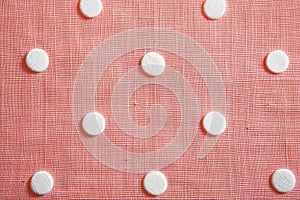A piece of cloth featuring white circles with dainty pink polka dots scattered across the canvas, Dainty pink polka dots scattered photo