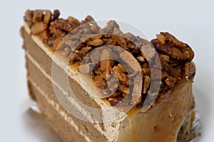 A piece of coffee almonds cake on white background