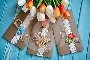 A piece of cotton lace with paper flowers and piece of brown paper