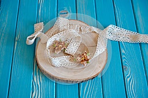 A piece of a cotton lace with paper flowers on a tree cut