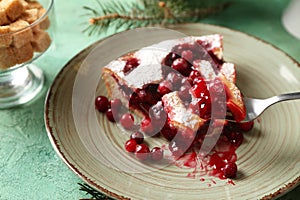 Piece of cranberry Christmas pie on fork over plate