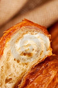 Piece of croissant pastry, extremely closeup photo