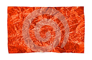 A piece of crumpled red foil on a white background. Foil
