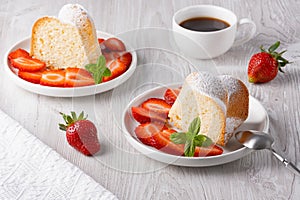 Piece of cupcake with strawberries on a plate