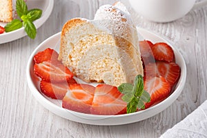 Piece of cupcake with strawberries on a plate