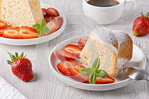 Piece of cupcake with strawberries on a plate