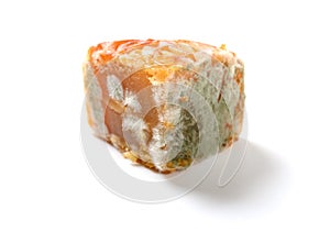 a piece of cut out moldy moon cake on white background