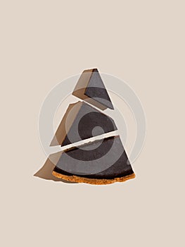 Piece of d?rk chocolate cheesecake on beige background