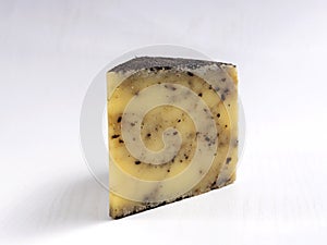 Piece of delicious cheese with malt on the white background