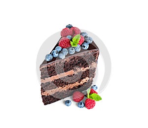 Piece of delicious chocolate cake with fresh berries on white background