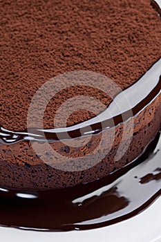 Piece of delicious chocolate cake with mint and fork on table, closeup