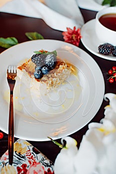 A piece of delicious Napoleon, decorated with blackberries and blueberries