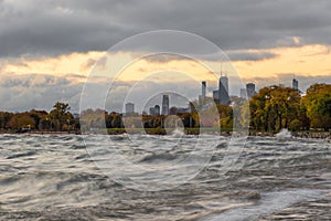 Piece of downtown Chicago along Lake Michigan with crashing waves and cloudy skies in the morning