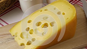 Piece of Dutch cheese with holes close up
