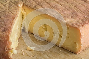Piece of French Munster cheese closeup photo